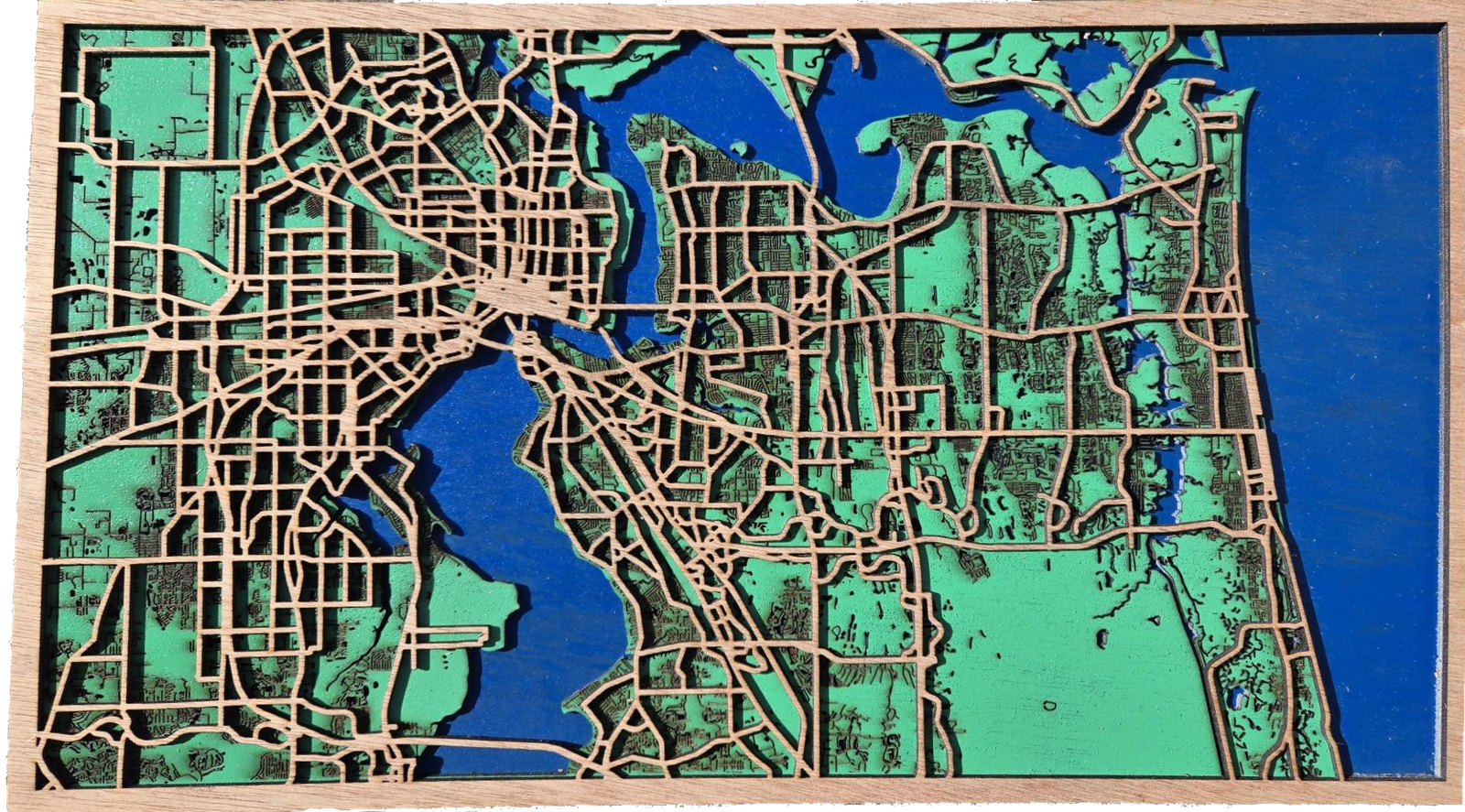 Handcrafted wooden map of Jacksonville featuring carved waterways and layered wood details