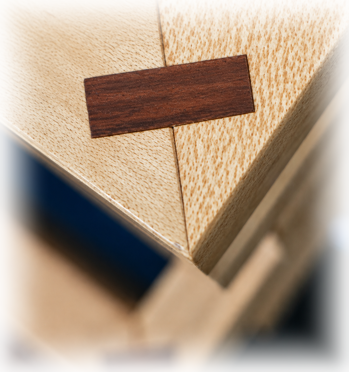 Fine woodworking detail showing the contrasting corner spline on a Greene & Greene inspired jewelry cabinet